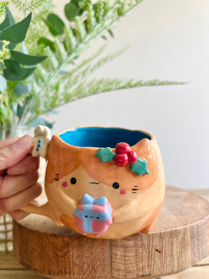 Festive gift bearing ginger cat mug with gingerbread friend