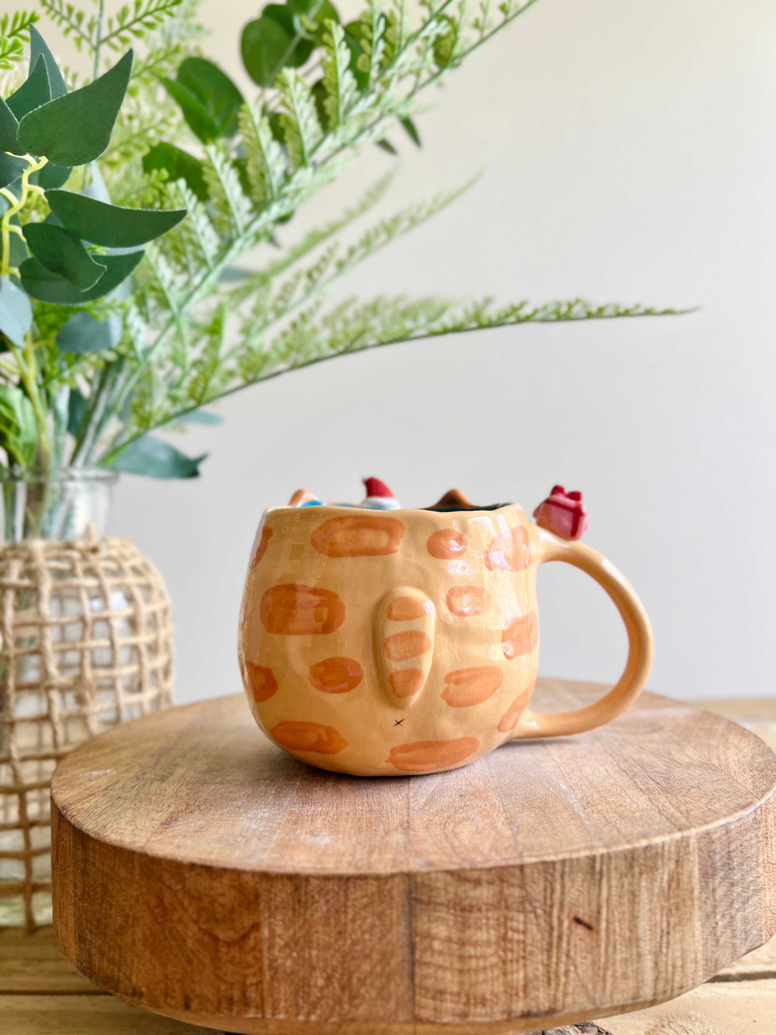 Ginger cat mug with gingerbread and present friend