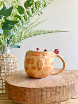 Ginger cat mug with gingerbread and present friend