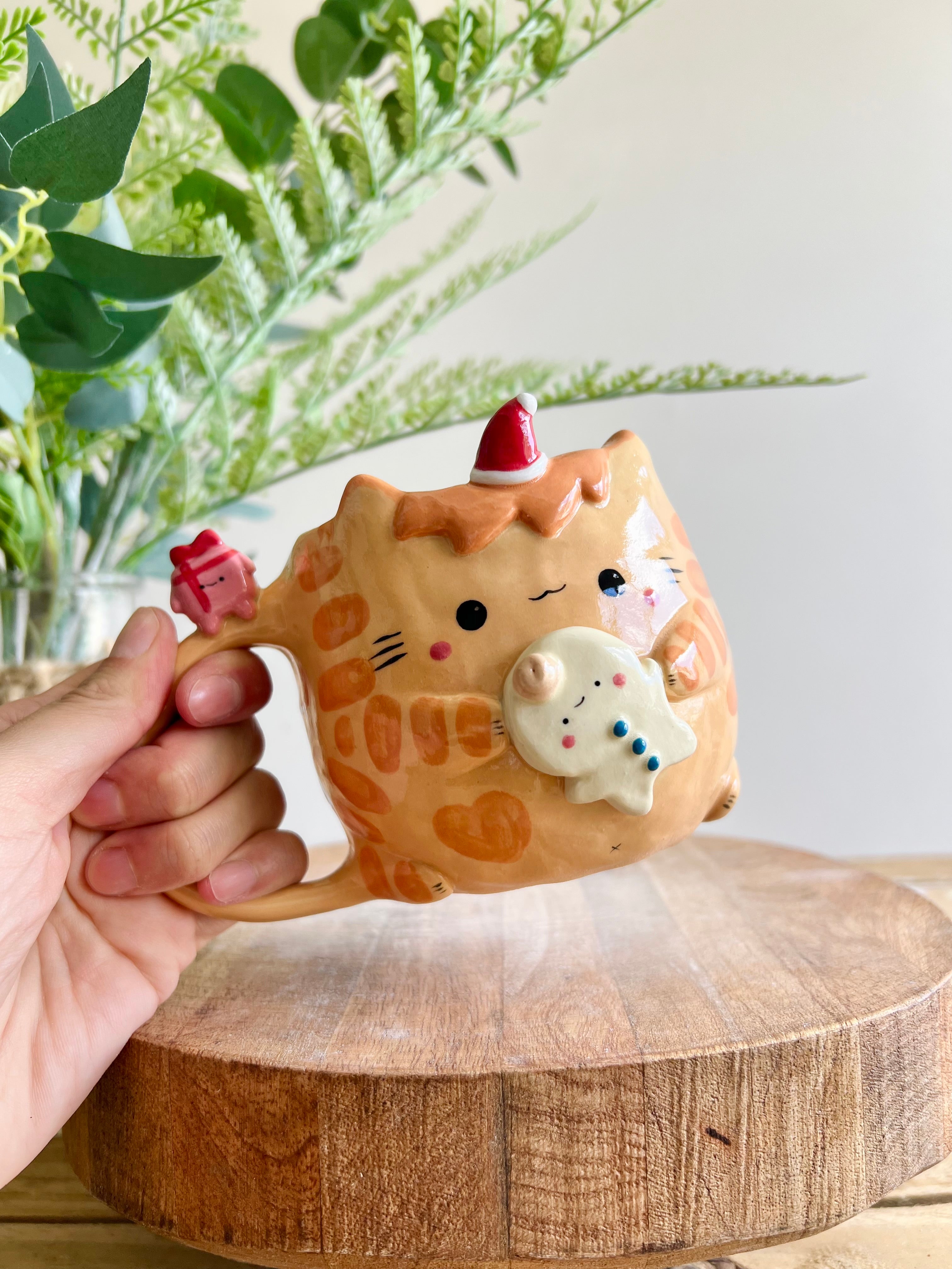 Ginger cat mug with gingerbread and present friend