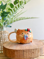 Festive gift bearing ginger cat mug with gingerbread friend