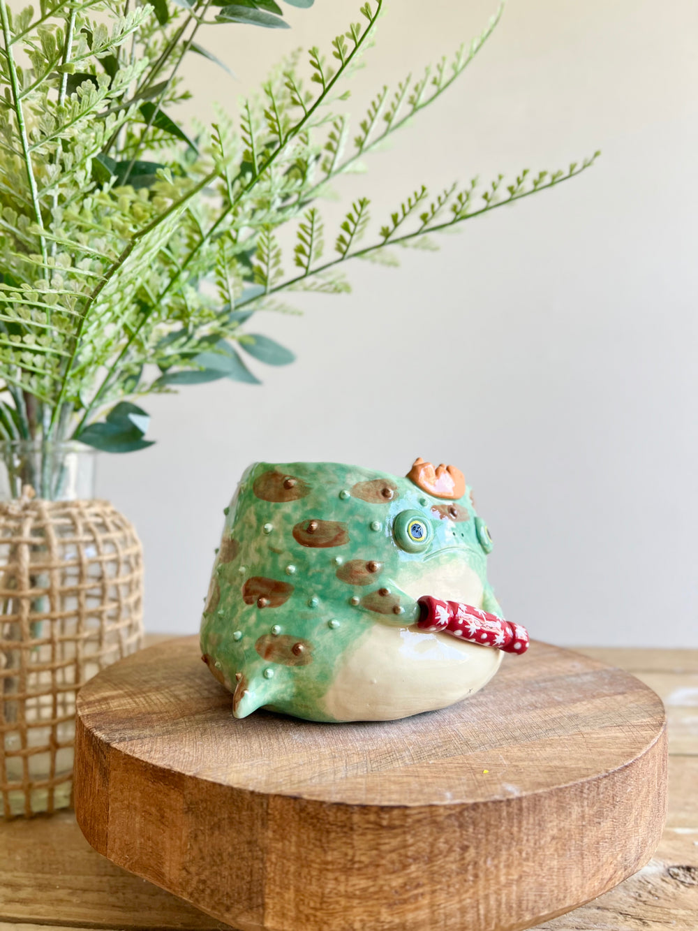 Festive grumpy Froggo planter cracks bon bon with you, photo 3 of 12