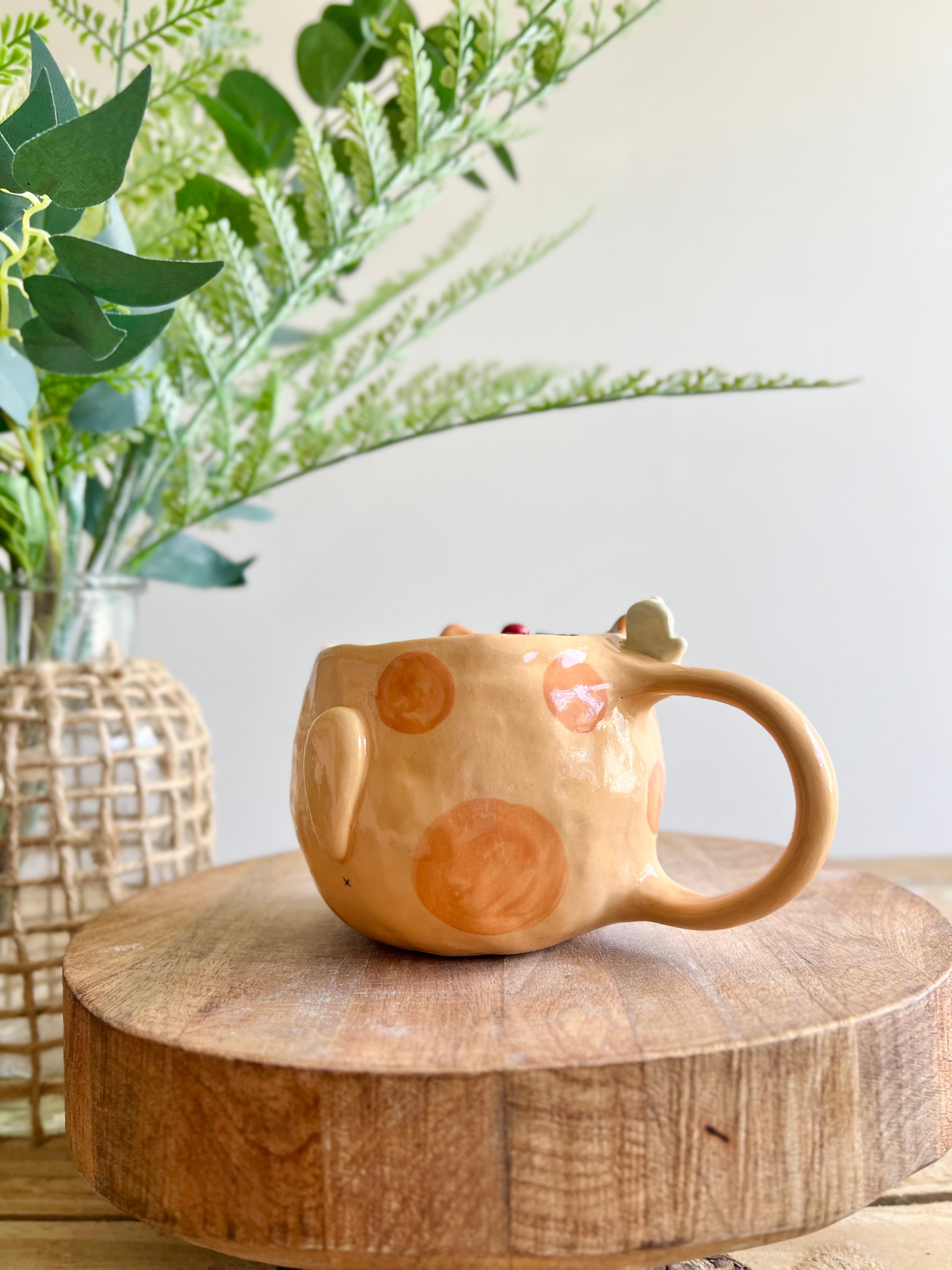 Festive gift bearing ginger cat mug with gingerbread friend