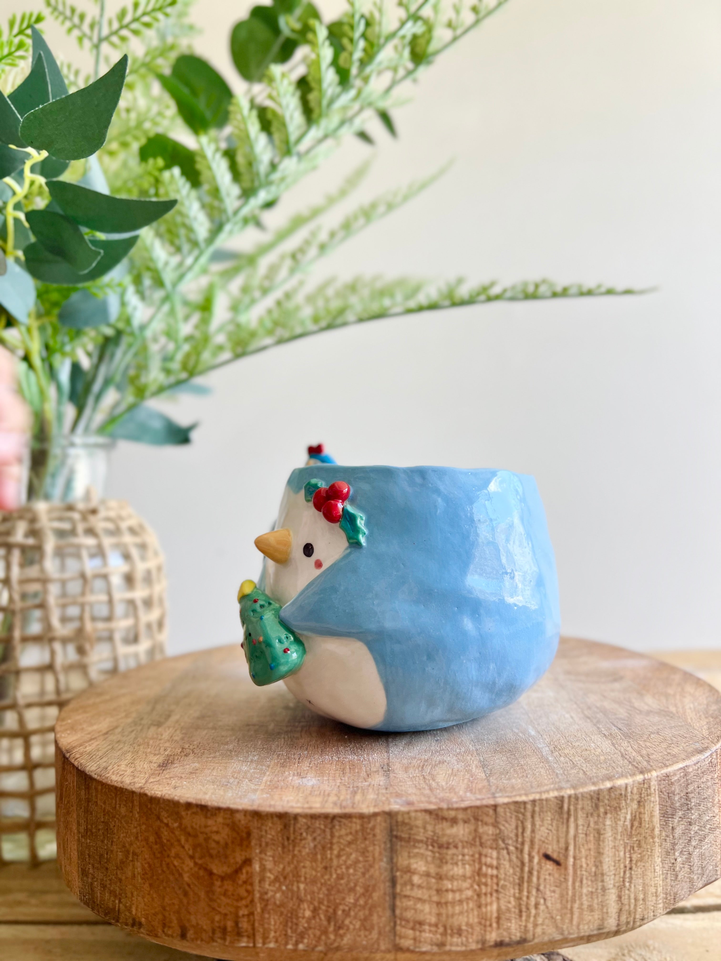 Festive Penguin mug with penguin baby and Christmas tree friend