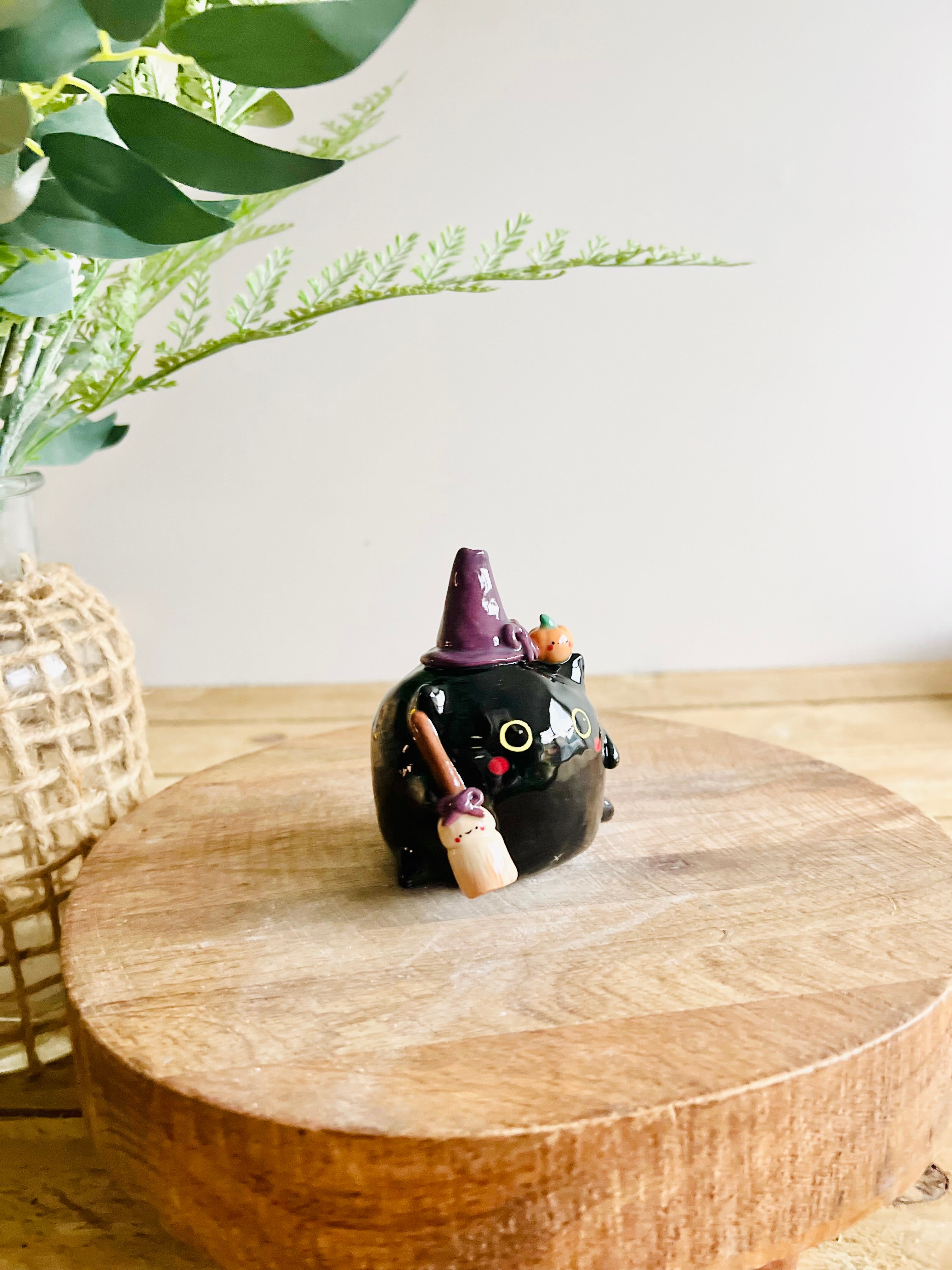 Black cat witch with broomstick and pumpkin friend bud vase