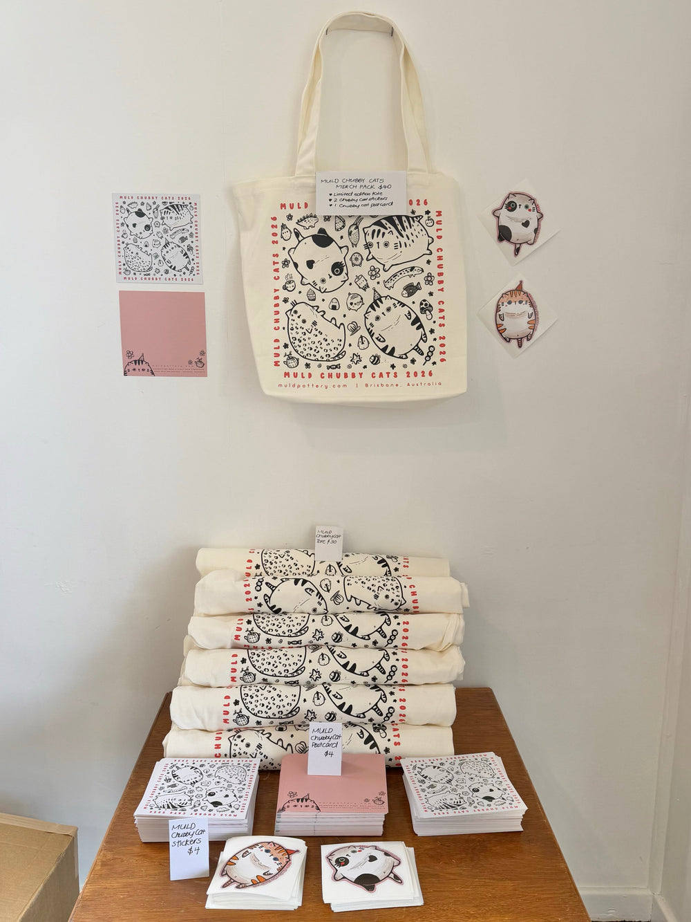 Chubby Cats exhibition merch pack display with tote, two stickers and postcard, photo 2 of 2