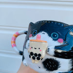 Black and white cat with bubble tea mug