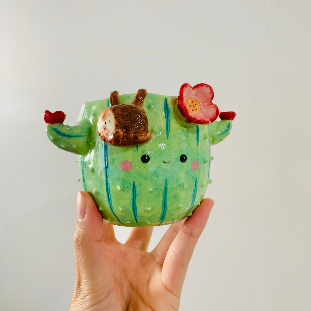 Flowery cactus pot with sloth friend