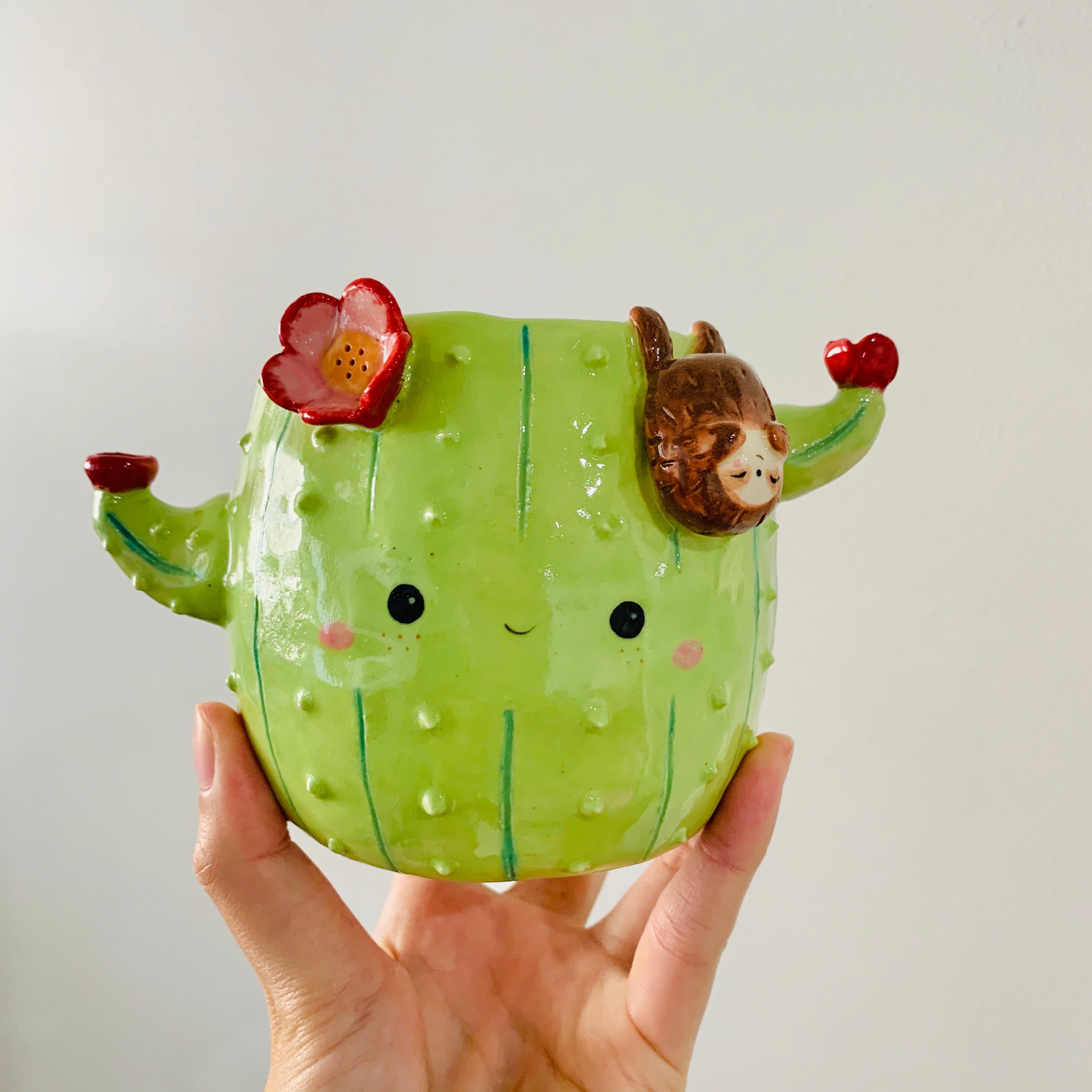 Flowery cactus pot with sloth friend