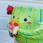 Dark green flowery cactus with bubble tea friend planter