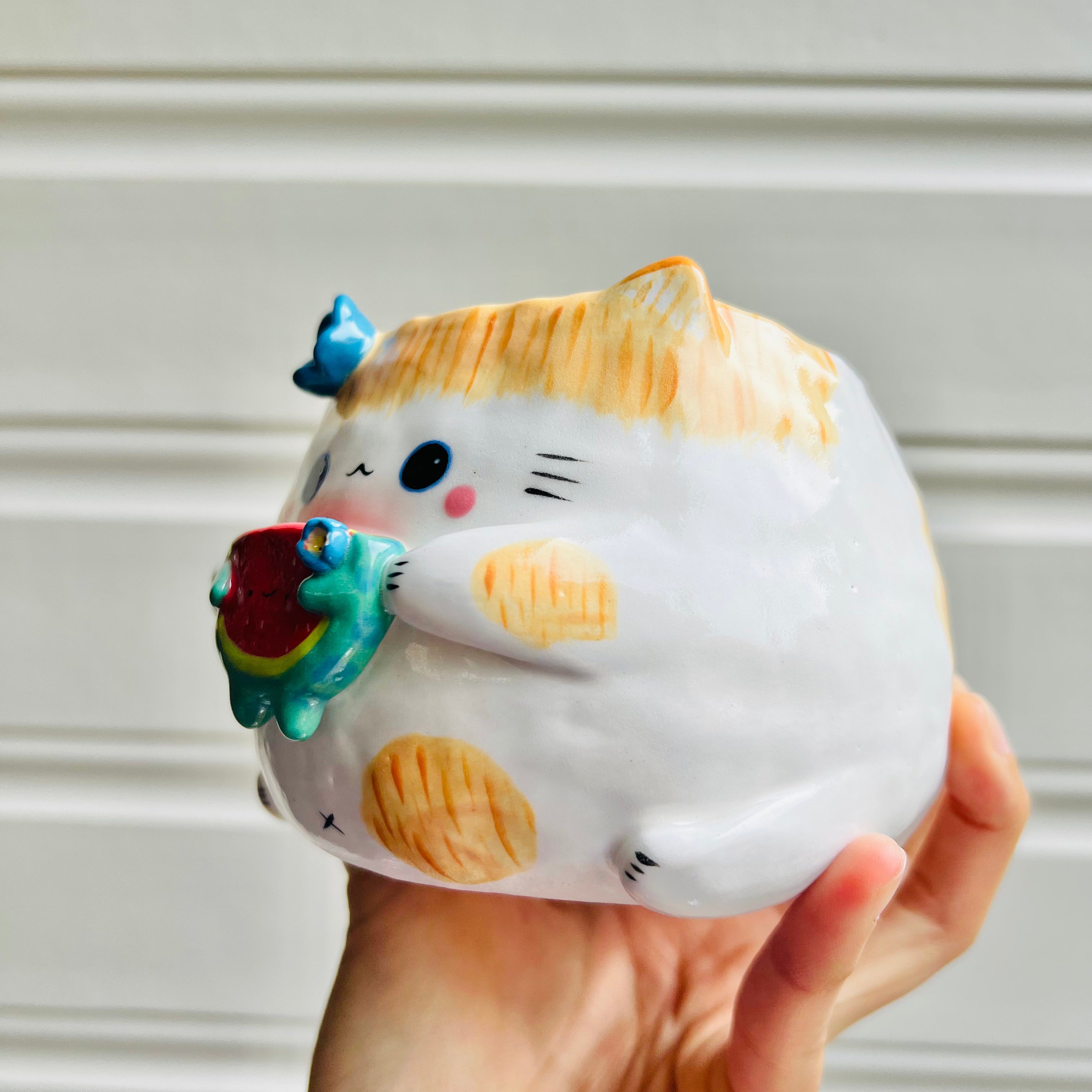 Ginger cat pot with watermelon friend