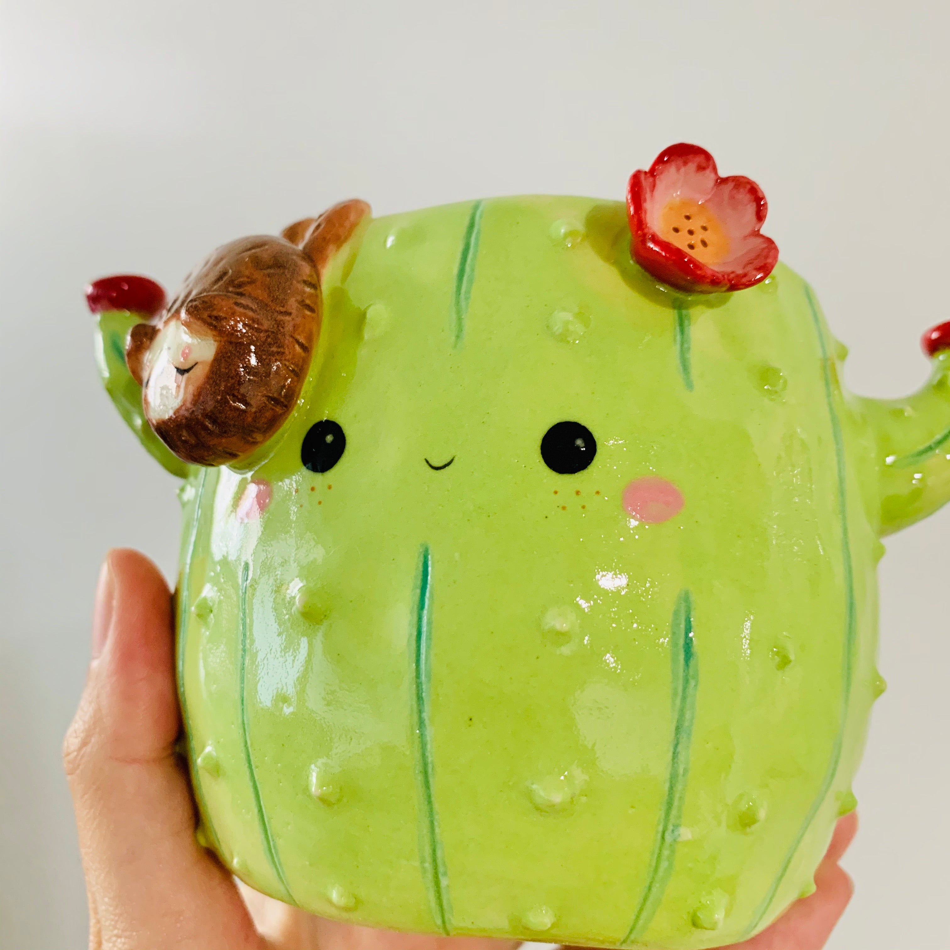 Flowery cactus pot with sloth friend