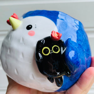 Penguin pot with black cat friend