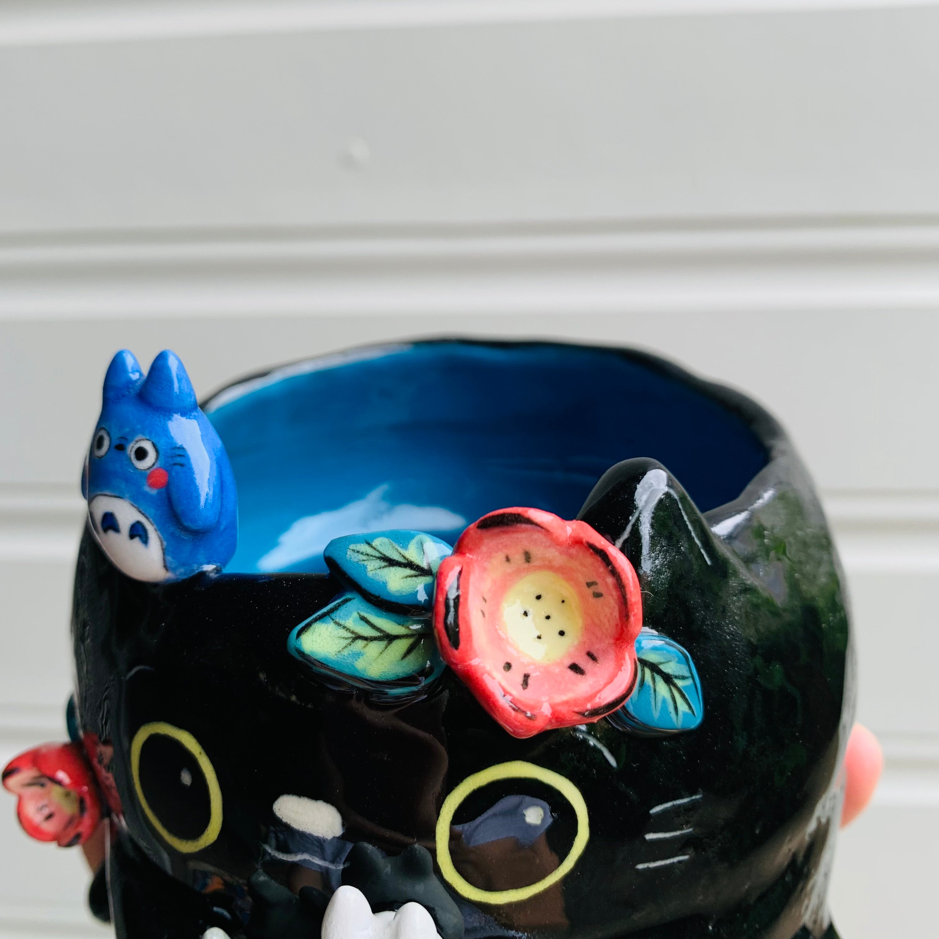 Flowery black cat pot with Totoro friends