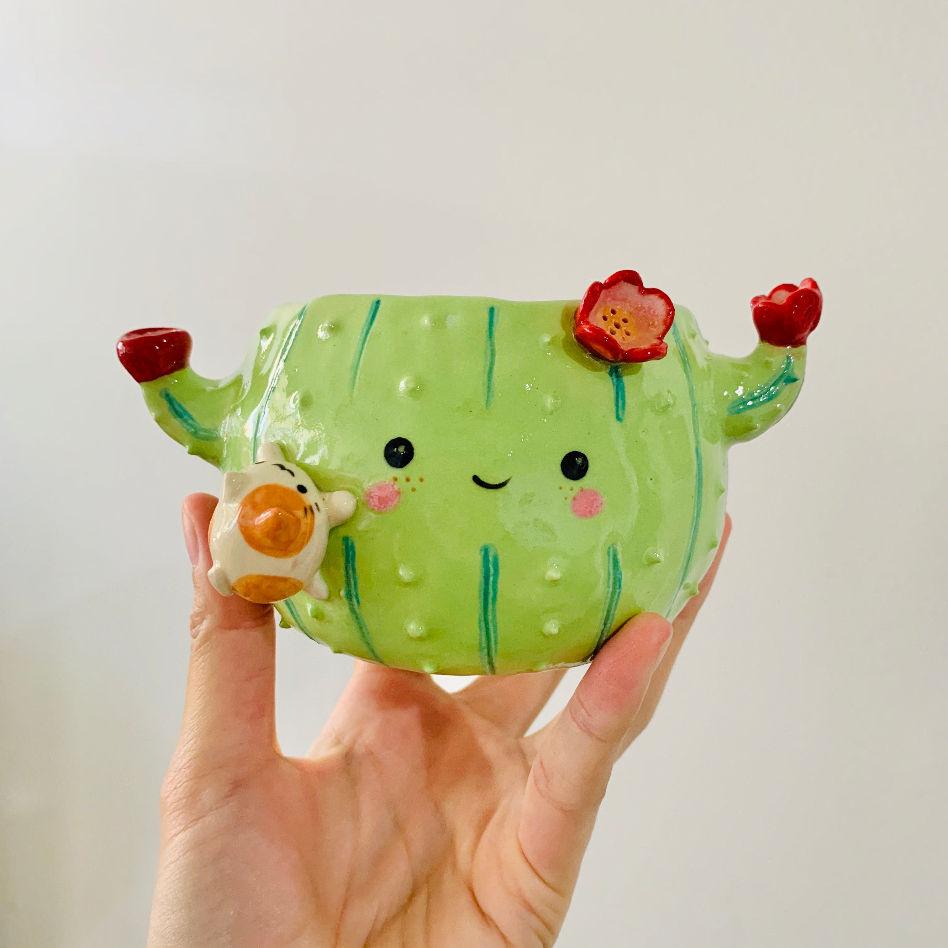 Flowery cactus pot with cat friend