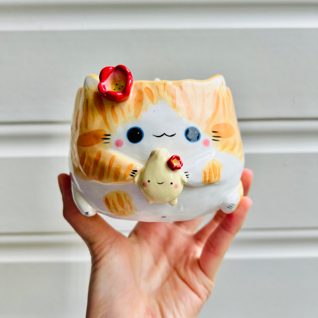 Ginger cat pot with dumpling friend