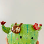 Flowery cactus pot with sloth friend