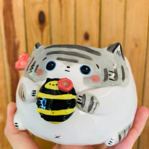 Stripey grey cat pot with bee friend