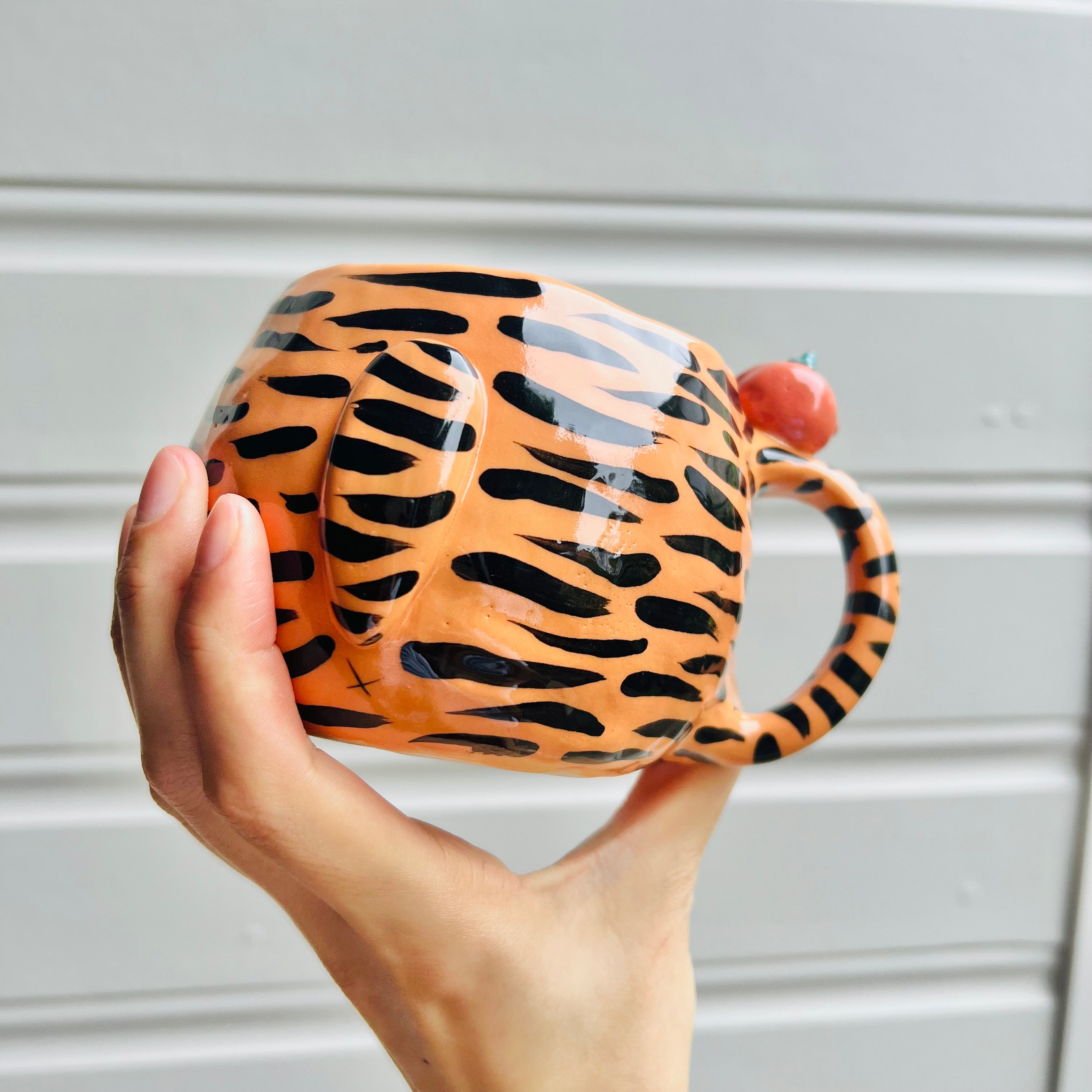 Hat wearing tiger and mandarin friend mug with red packet