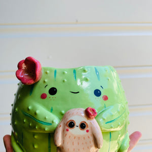 Flowery cactus pot with sloth friend