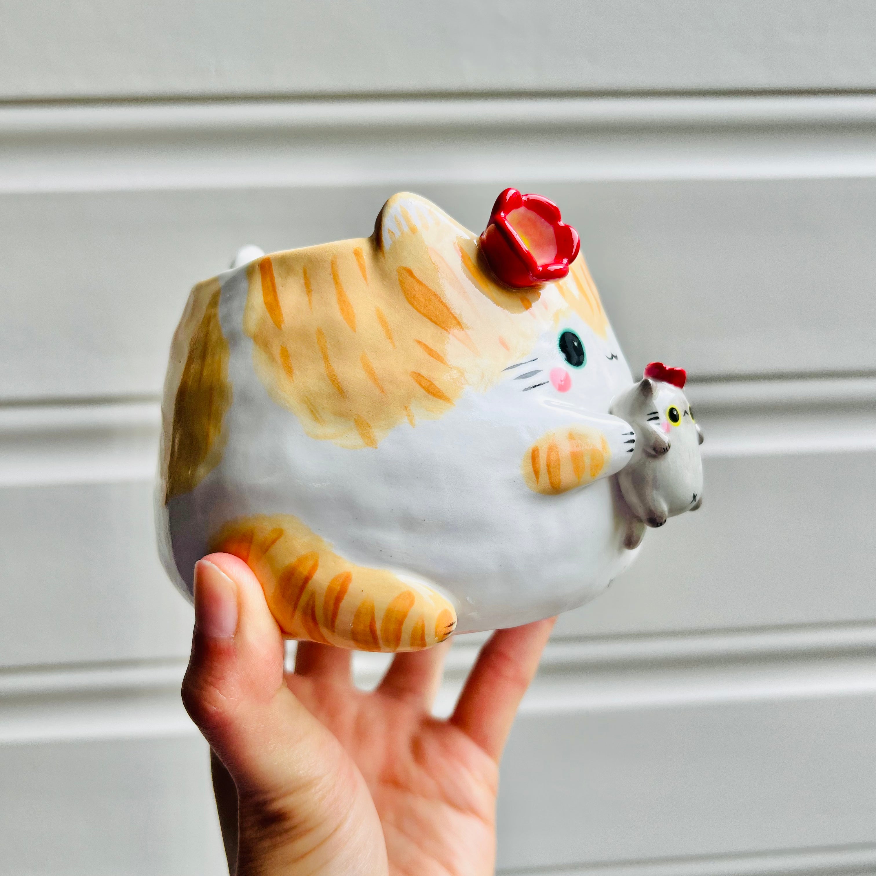 Ginger cat pot with grey cat friend