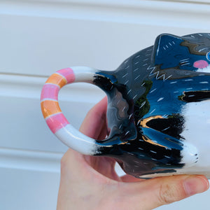 Black and white cat with bubble tea mug