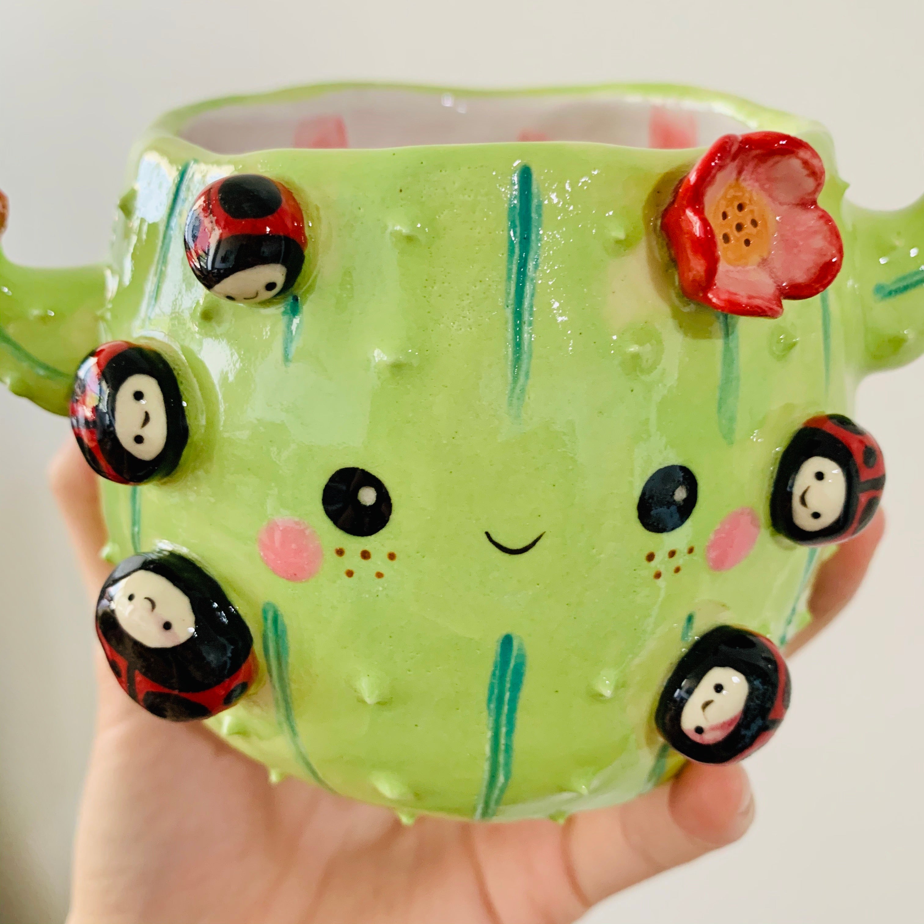 Flowery cactus pot with lady bug friends