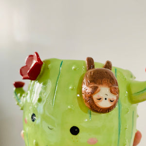 Flowery cactus pot with sloth friend