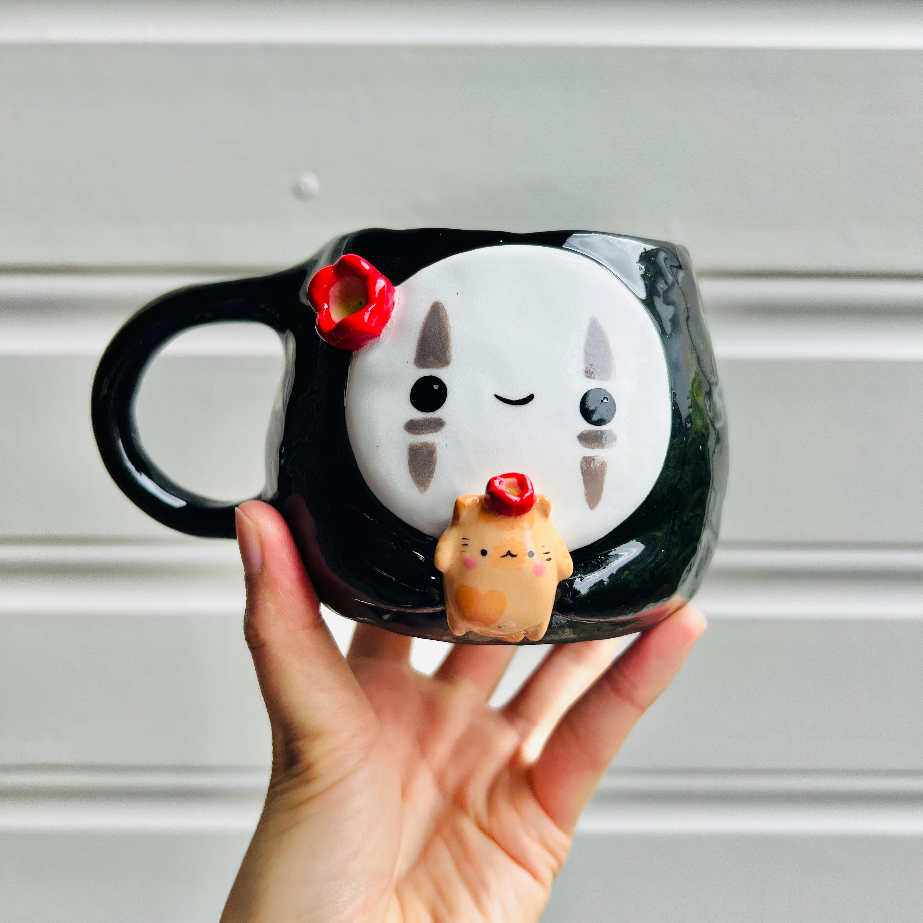 No Face mug with ginger cat friend