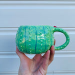 Dark green flowery cactus with bubble tea mug