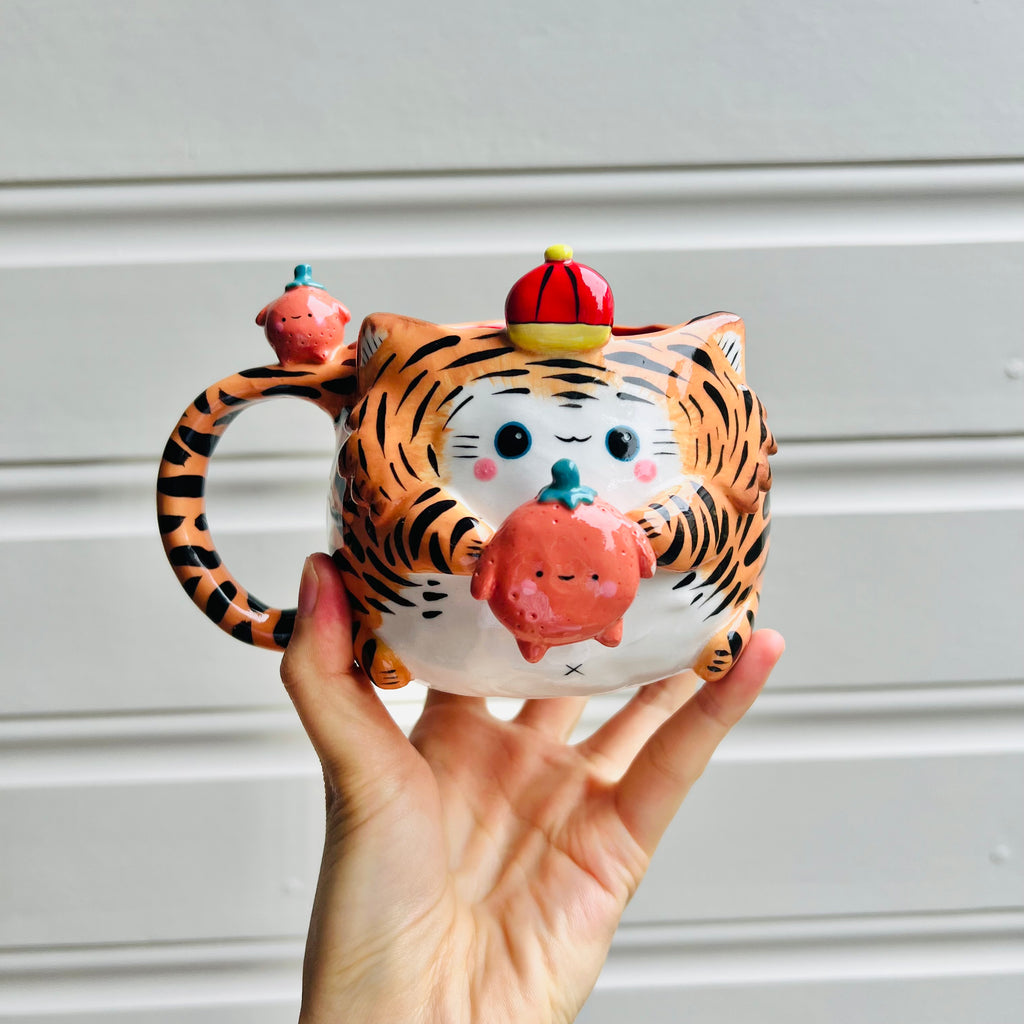 Hat wearing tiger with mandarin friend mug with mandarin