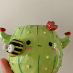 Flowery cactus pot with busy bee friend