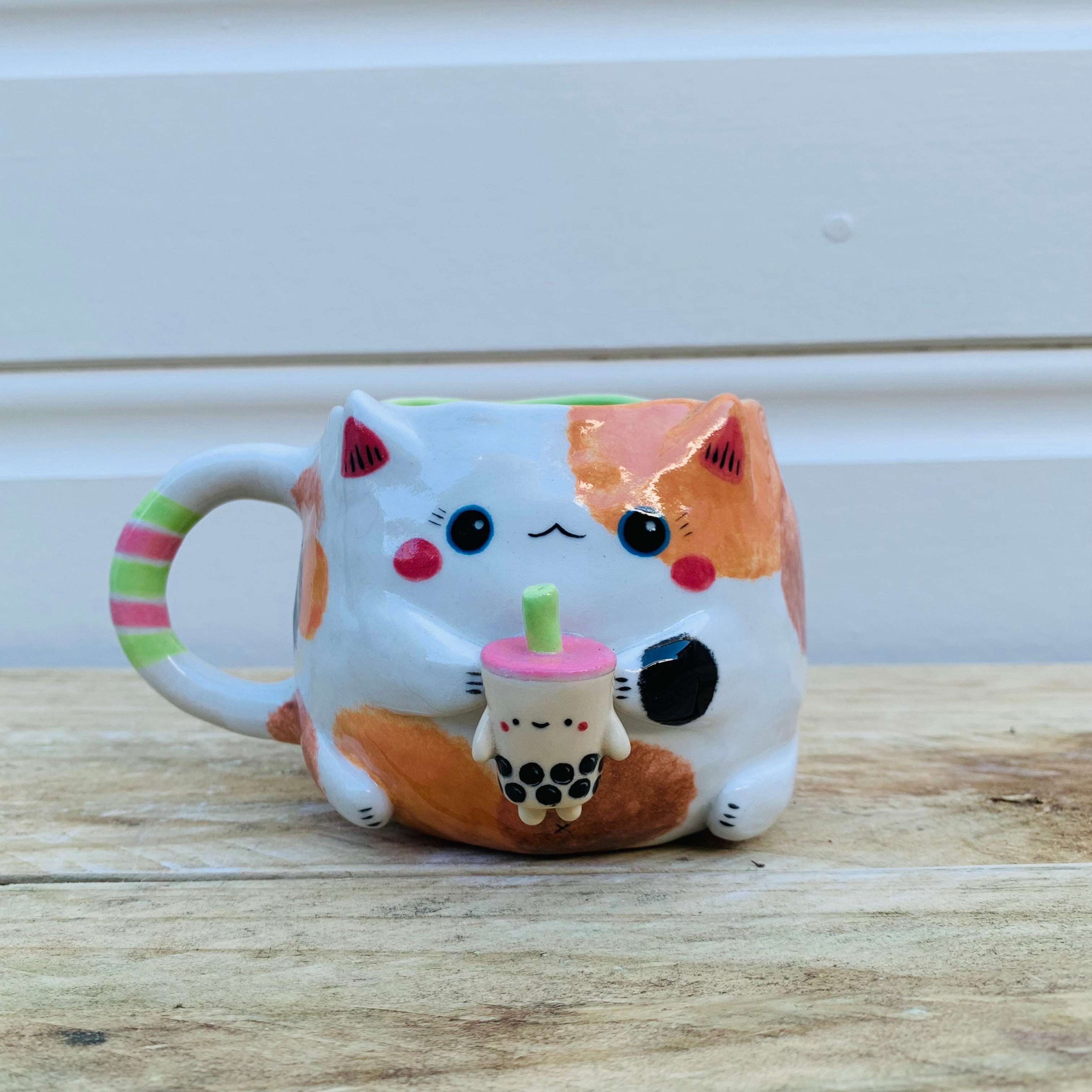 Spotty cat with bubble tea mug