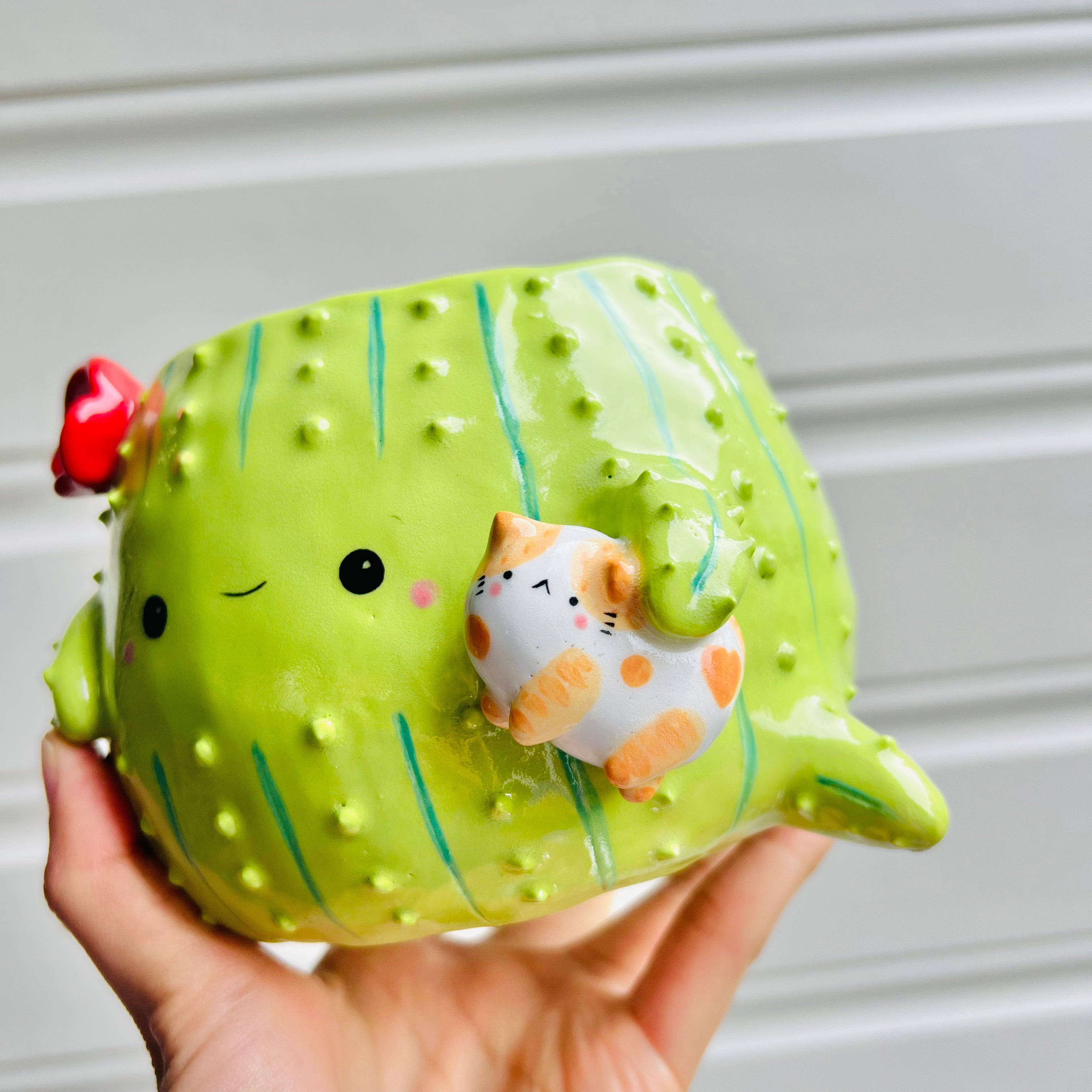 Large flowery cactus pot with ginger cat friend