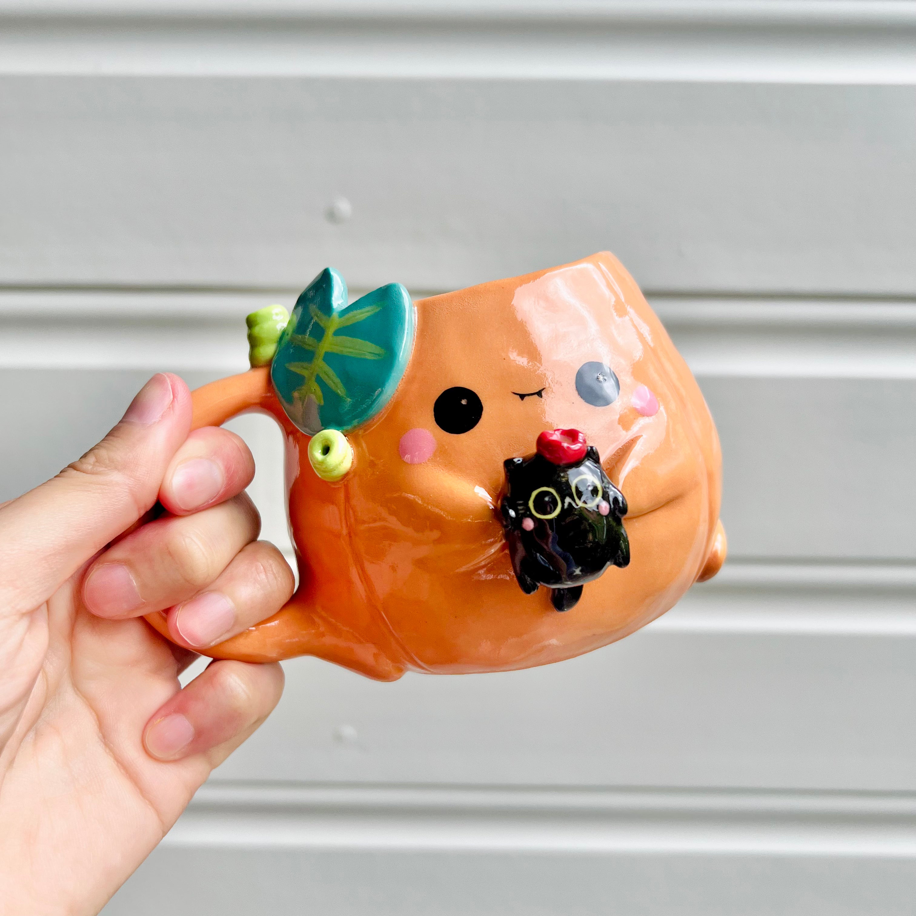 Halloween pumpkin mug with black cat friend