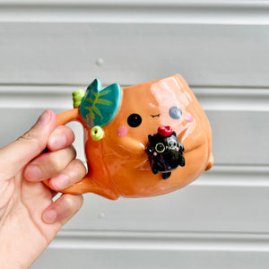 Halloween pumpkin mug with black cat friend