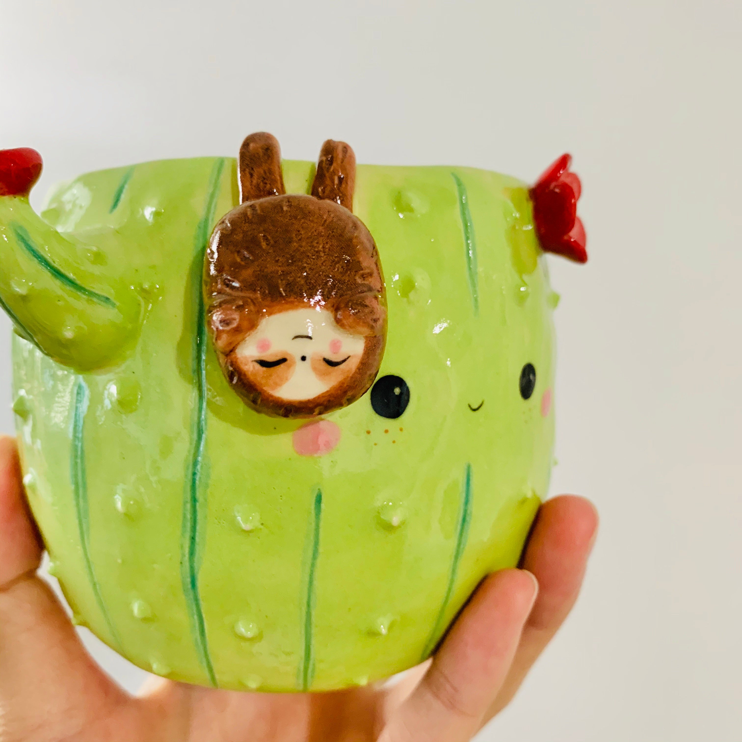 Flowery cactus pot with sloth friend