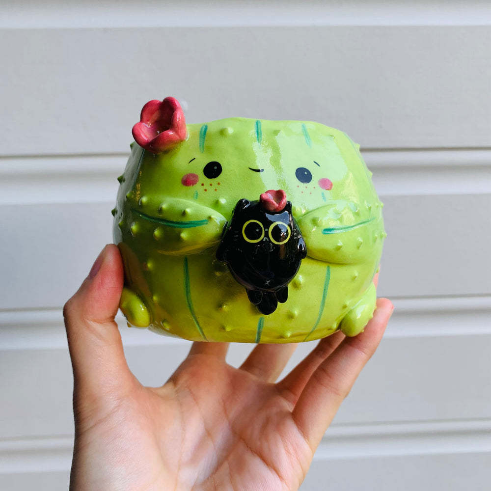 Flowery cactus pot with black cat friend, photo 1 of 6