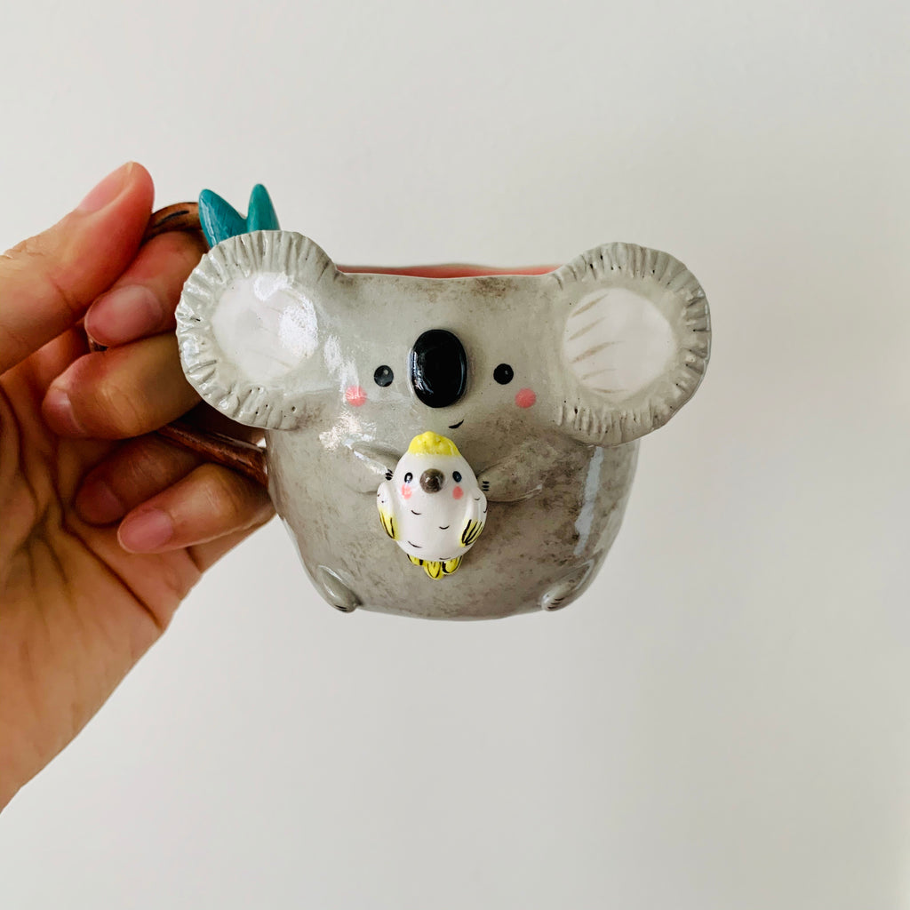 Koala with cockatoo friend mug