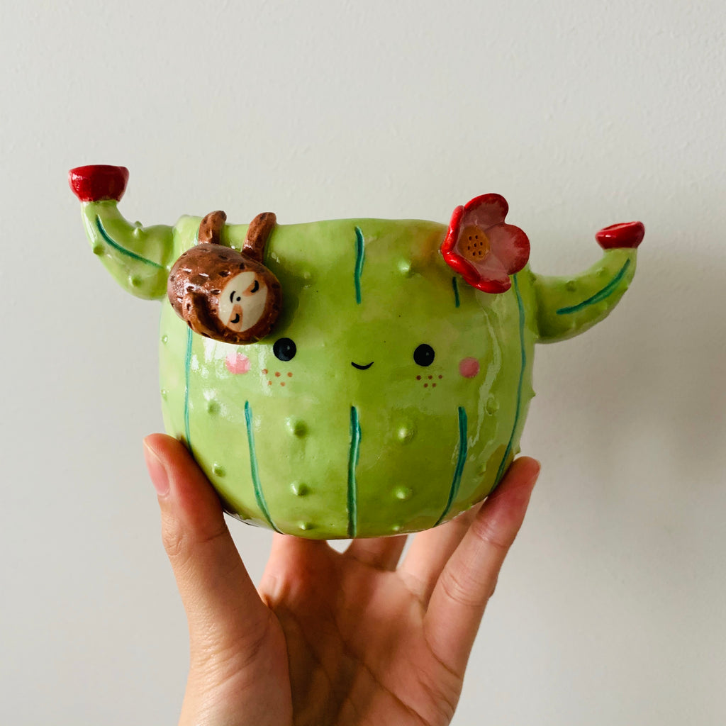 Flowery cactus pot with sloth friend