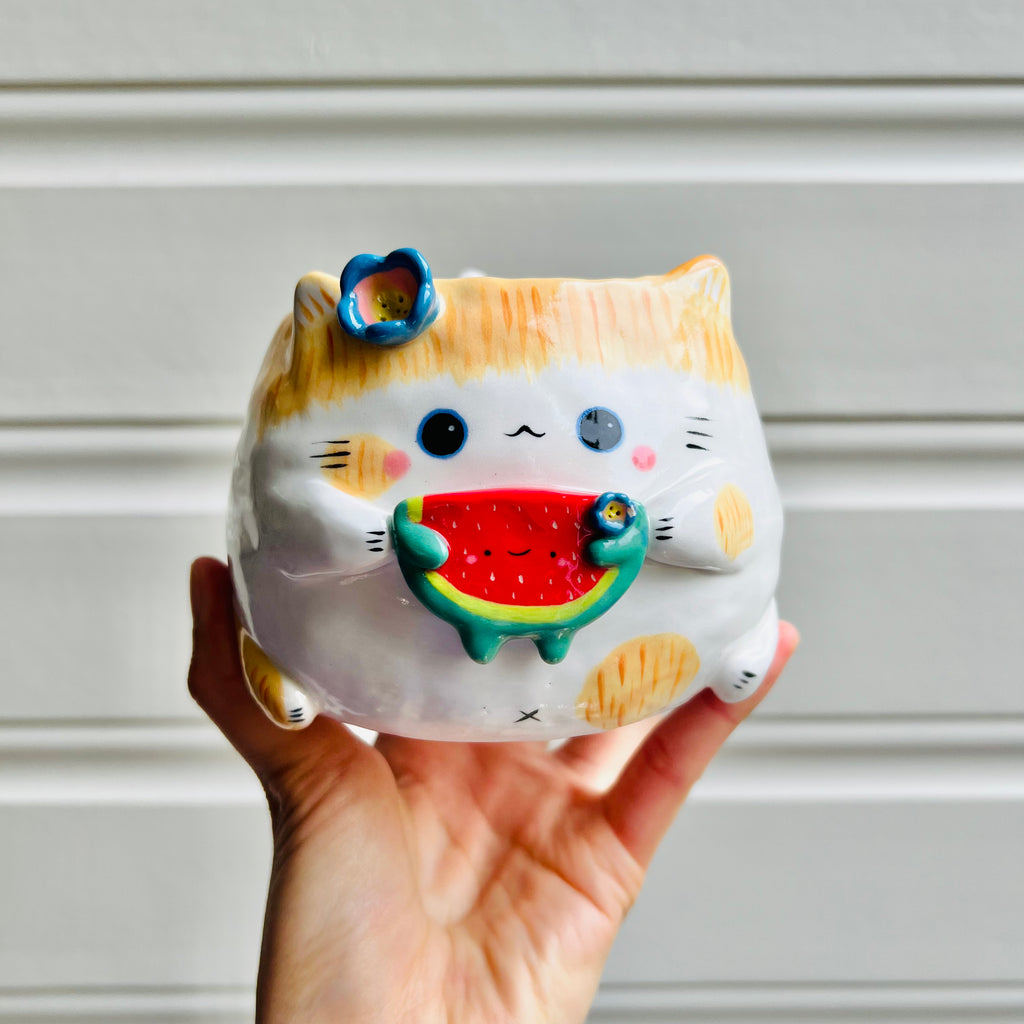 Ginger cat pot with watermelon friend