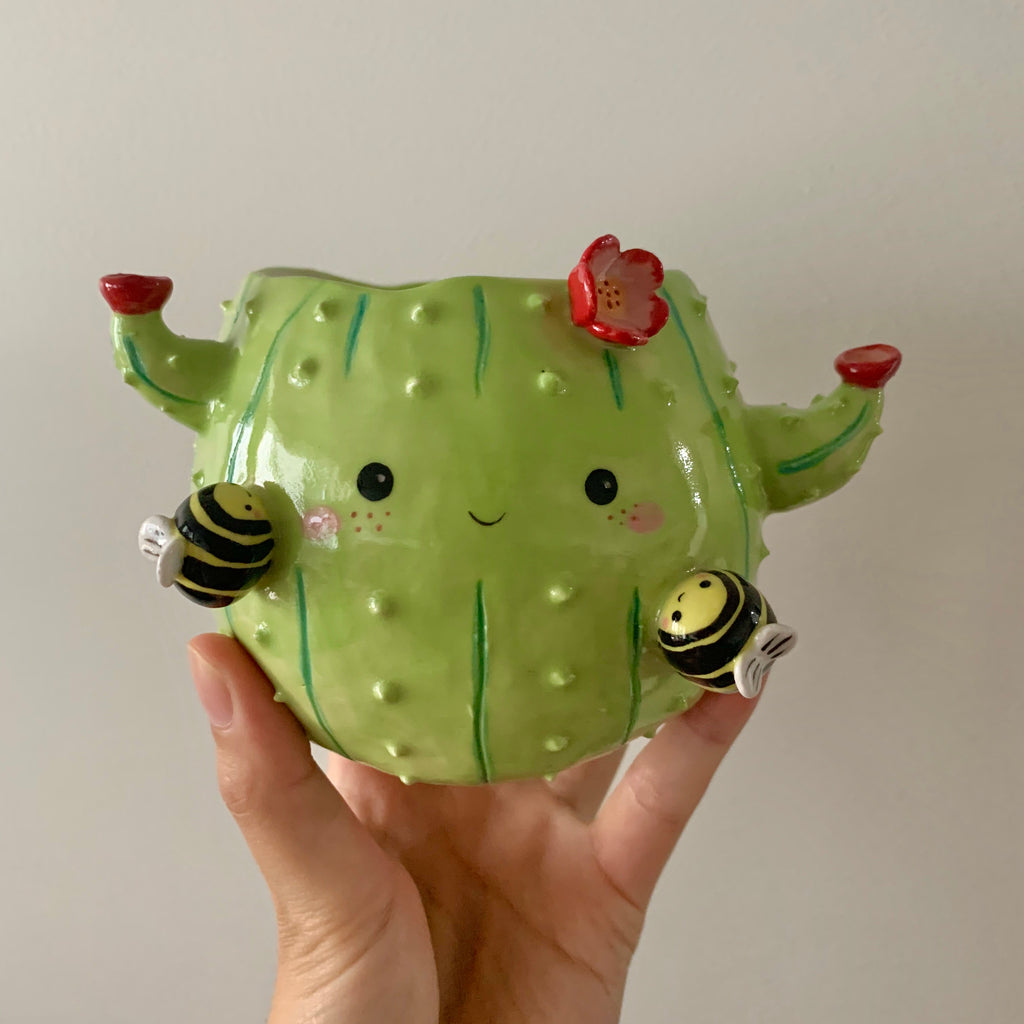 Flowery cactus pot with busy bee friends