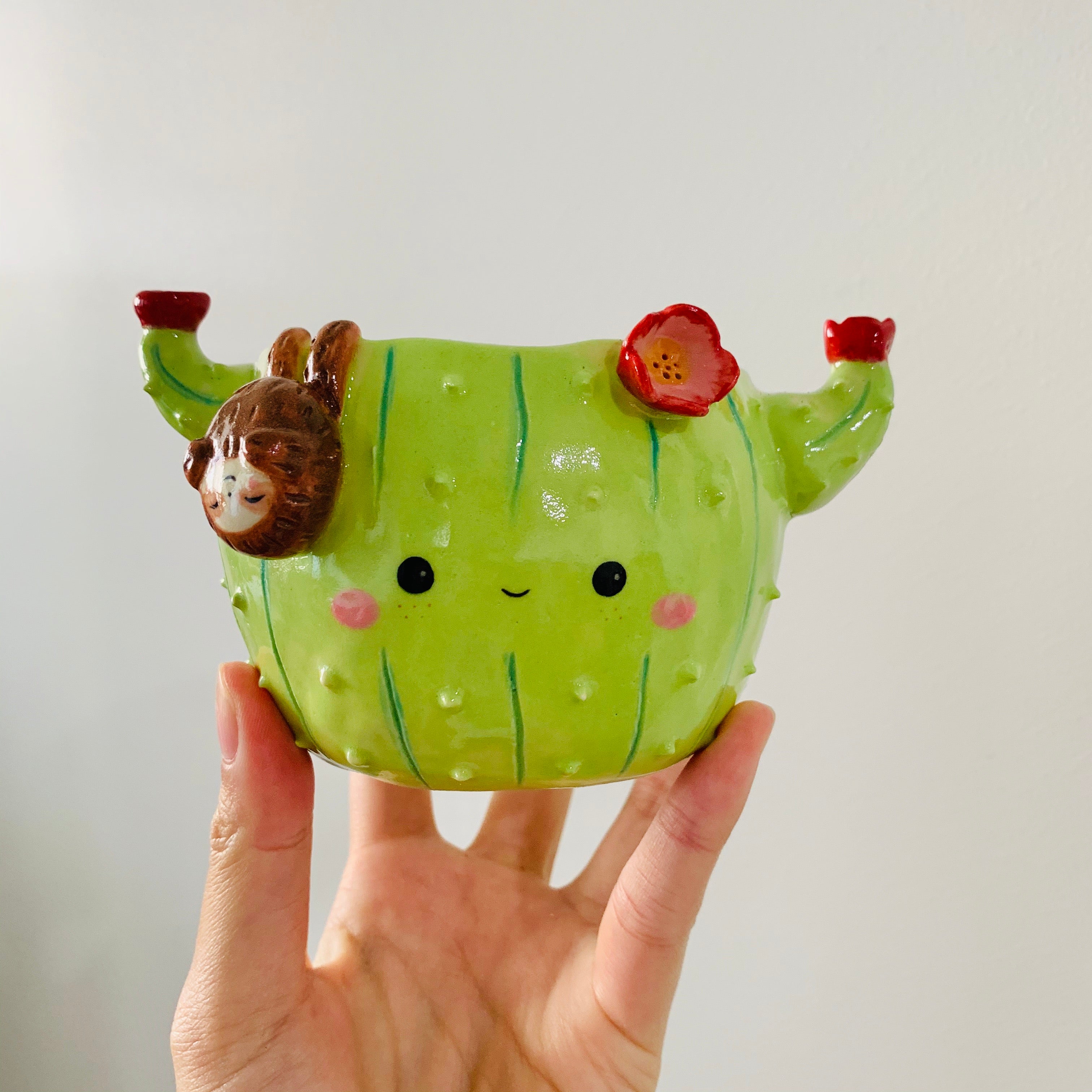 Flowery cactus pot with sloth friend