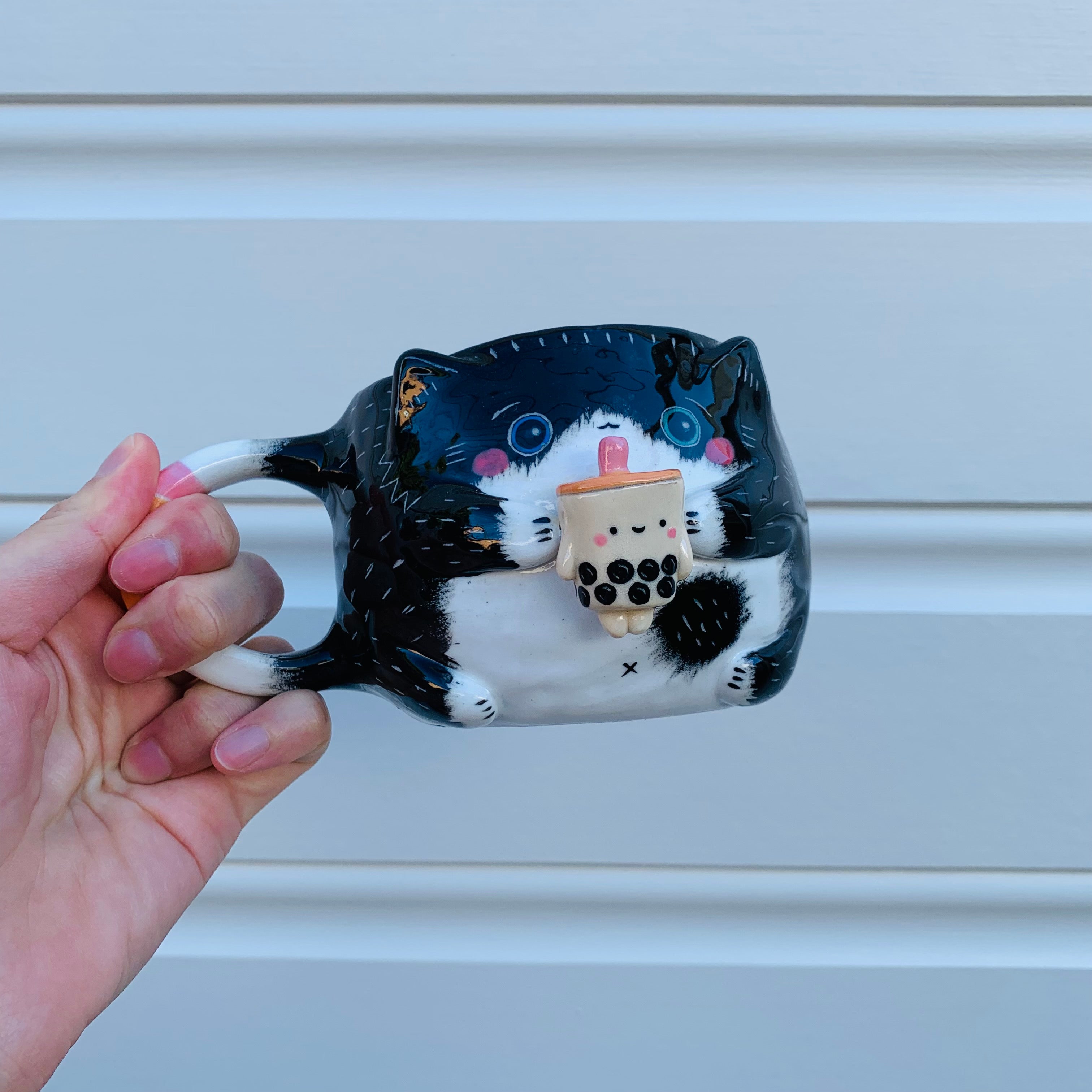 Black and white cat with bubble tea mug