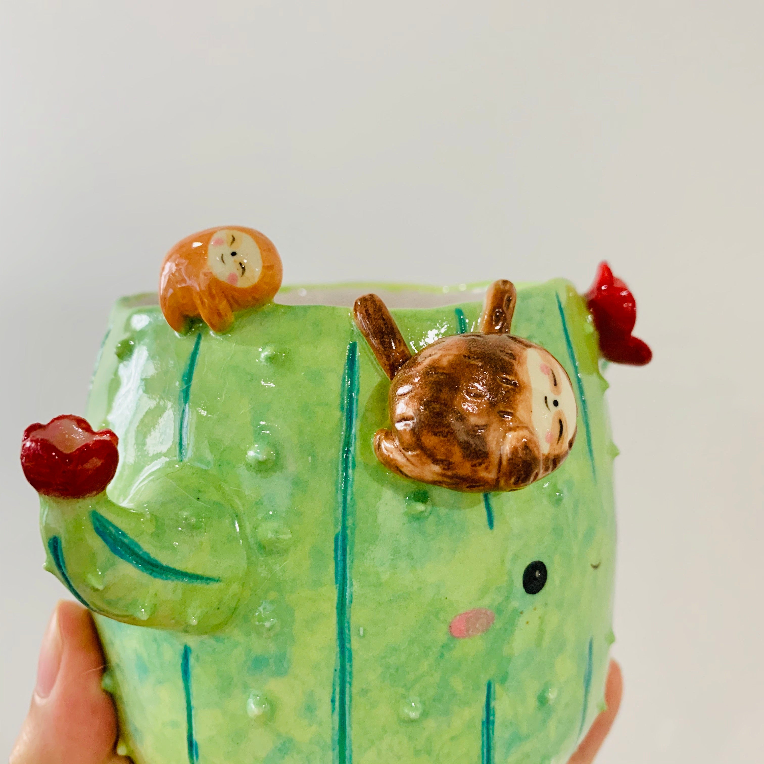 Flowery cactus pot with sloth friends