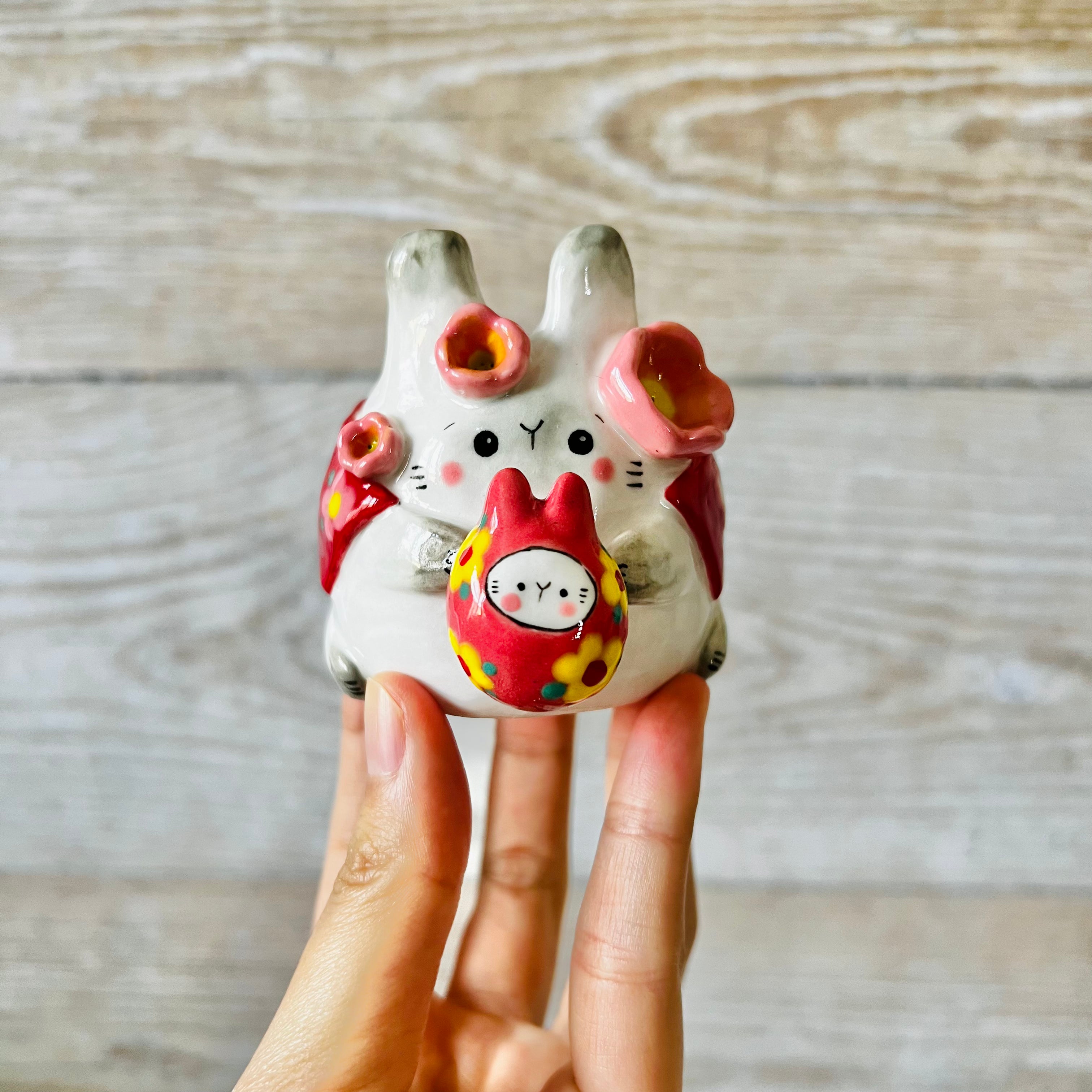 LNY cape wearing bunny vase with Daruma friend