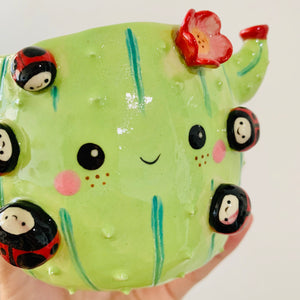 Flowery cactus pot with lady bug friends