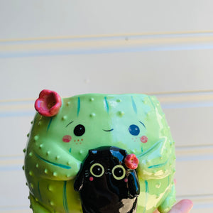 Flowery cactus pot with black cat friend