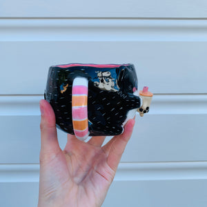 Black and white cat with bubble tea mug