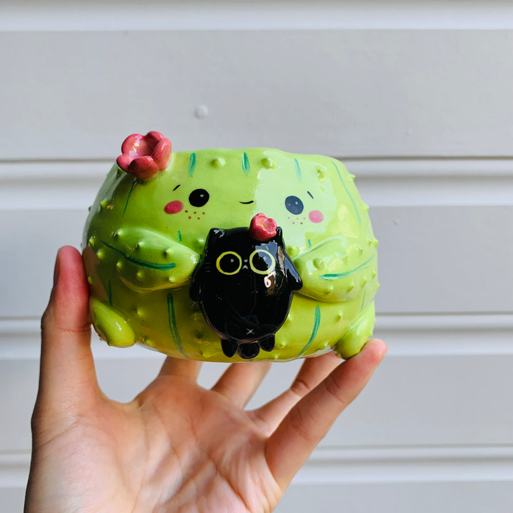 Flowery cactus pot with black cat friend, photo 1 of 6